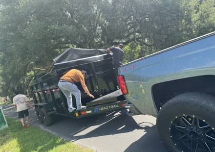 The RHR crew loading furniture into the dump trailer