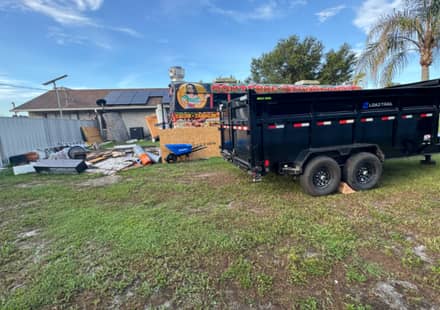 RHR trailer parked at a Florida back-yard clear-out in progress